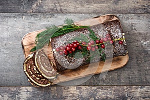 Chocolate yule log christmas cake with red currant