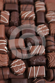 Chocolates assortment set.Chocolate sweets.Chocolate pattern. Candy close-up on a brown background.dark milk chocolates