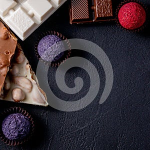 Chocolates background. Chocolate. Assortment of fine chocolates in white, dark, and milk chocolate. Praline Chocolate sweets