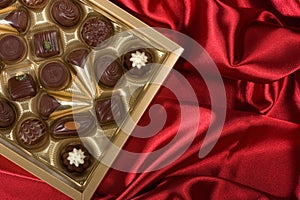 Chocolates box on red satin