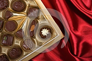 Chocolates box on red satin