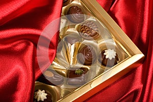 Chocolates box on red satin