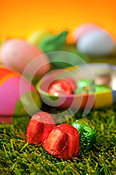 Chocolates and estar eggs on the grass photo
