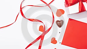 chocolates, love letter envelope, gift box on white background . Valentine`s day celebration concept. Copy space. Flat lay