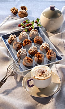 Chocolates with nuts and a capuccino photo