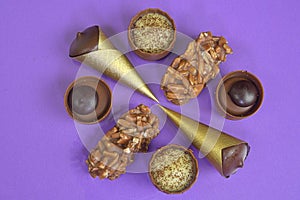 Chocolates praline variety on pastel background with copyspace. Assortment of fine chocolate candies, white, dark and