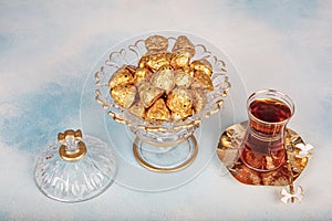 Chocolates wrapped in foil in luxury candy. Chocolate candies in a box in a gold wrapper