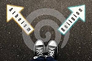 Choice between atheism and religion. Woman standing on road near arrows marking, top view