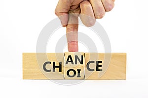 Choice and chance symbol. Businessman turns the wooden cube and changes the word choice to chance. Beautiful white table, white