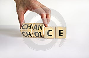 Choice and chance symbol. Businessman turns wooden cubes and changes the word `choice` to `chance`. Beautiful white table, whi