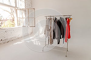 A choice of clothes on a rack. Wardrobe rack with stylish clothes