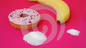 Choice donut against banana. Starting healthy eating or junk food