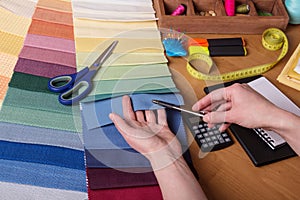 Choice of fabric for sewing, sewing accessories on table