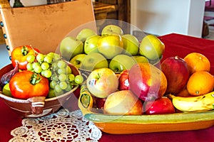 Choice, fresh Fruit in three beautiful bowls on a red tablecloth with white lace