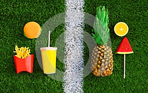 Choice of healthy or unhealthy food concept - burger, french fries, cup of juice and pineapple, lollipop or ice cream shaped slice