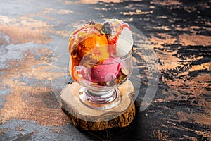 choice of ice cream three scoop served in dish isolated on dark background side view