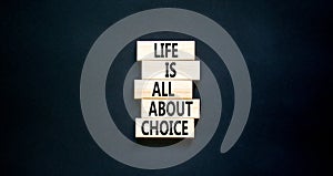 Choice and life symbol. Concept words Life is all about choice on wooden blocks. Beautiful black table black background. Business