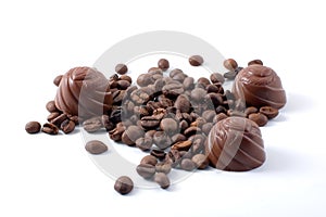 Chokolate candies and scattered coffee grains