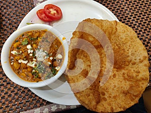 Chola bhatura. Famous Indian meal chik peas curry with flour fried poori or puri and salad. photo