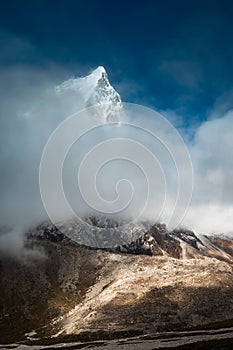 Cholatse 6335 m mountain summit hidden in clouds