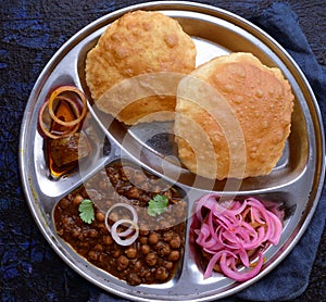 Chole Bhature meal with pickle and onions