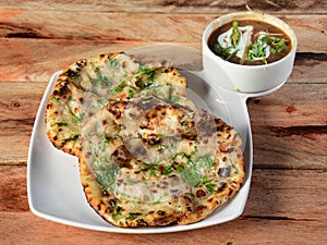 Chole Kulcha, Clay baked stuffed Naan served with chole masala, typical meal of Amritsar, India.