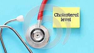 Cholesterol level words on a yellow piece of paper and blue background