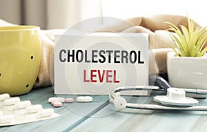 Cholesterol LEVELS text on paper with heart