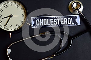 Cholesterol on the paper with Healthcare Concept Inspiration. alarm clock, Black stethoscope.