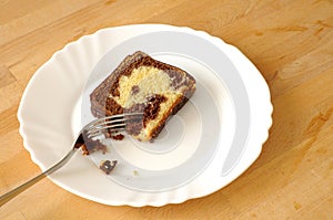 Chololate marble cake in a plate nibbled with a fork