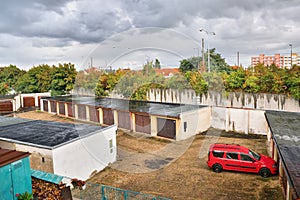 Chomutov, Czech republic - September 17, 2017: Garages with red car in Chomutov city after unexpectedly strong rain at beginning a