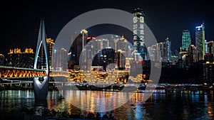 Chongqing city nightscape with bridge buildings and Hongya Cave view illuminated at night in Chongqing China