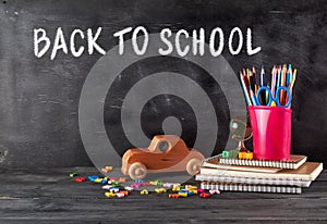 chool supplies: notebook, pencils, scissors and a wooden retro toy car