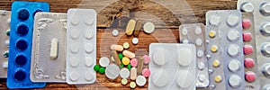 Choose between drugs for colds and flu: traditional tablets and alternative natural remedies. Vintage wooden background