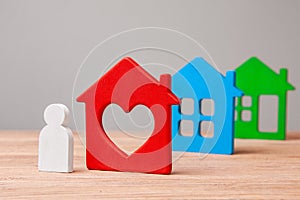 Choose a house to buy or rent. Little man and colorful houses