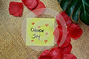 Choose Joy write on sticky notes isolated on Wooden Table