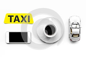 Choose a taxi in mobile application. Taxi label, cell phone, car toy on white background top view