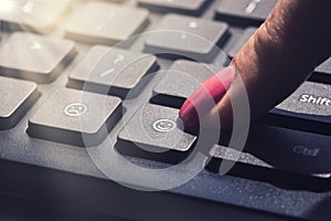 Choose to be happy or joy lifestyle abstract button at computer keyboard pressed by woman finger