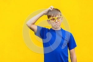 Choosing concept. Pondering freckled boy looking up and thinking