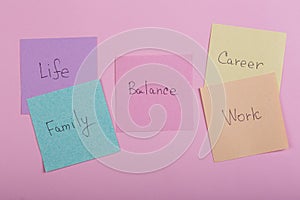 Choosing family or career concept - colorful sticky notes with words balance, work, career, family, life