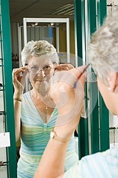 Choosing glasses at the optician photo