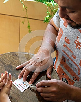 Choosing nail stickers for the nails. Father and little girl quality time