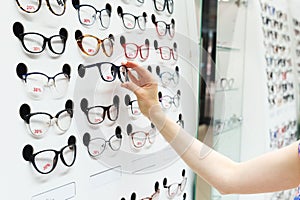 Choosing new optical glasses in optician shop