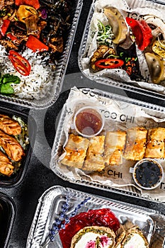 Choosing take away food. Spring rolls, dumplings, gyoza and dessert in lunch box. Take and go organic food. Thai and Asian