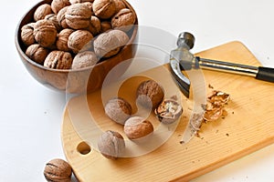 Chop  walnuts with a hammer on a cutting board. strong natural walnuts in  kitchen