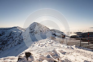 Chopok in Low Tatras national park with mountain hut and Jasna ski resort cableway station in winter. Liptov region. Demenovska wa