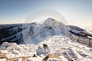 Chopok in Low Tatras national park with mountain hut and Jasna ski resort cableway station in winter. Liptov region. Demenovska wa