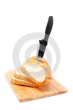 Chopped bread with knife and wooden board