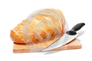 Chopped bread with knife on wooden utensil