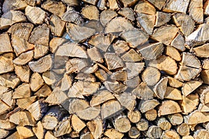 Chopped brown firewood, stacked and ready for winter